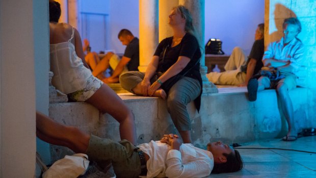 Audience members – exhausted, listening hard or both – at a music performance in the Rector's Palace atrium.