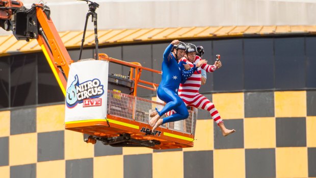 Nathan Hindmarsh and Bryan Fletcher jump from a crane onto a 'blob' floating in Darling Harbour for a world record attempt with Nitro Circus star Ethan Roberts.