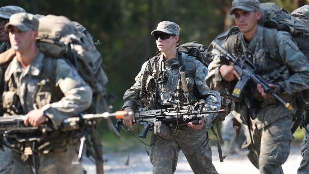 A female Army Ranger marches with her unit during Ranger School.