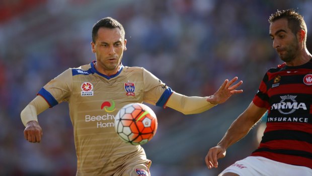 Eyes on the ball: Milos Trifunovic tries to control possession for Newcastle against Western Sydney.
