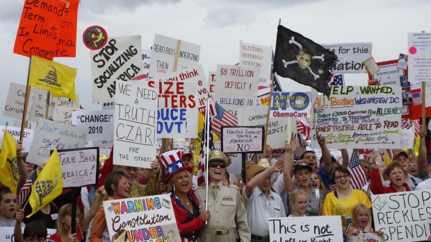 People hold signs during a Tea Party protest in Flagstaff, Arizona.