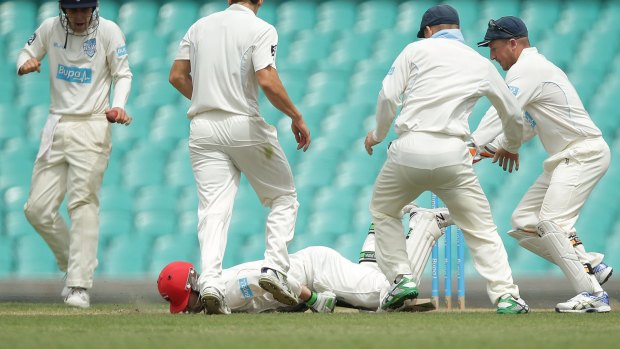 Hughes falls face down on the pitch.