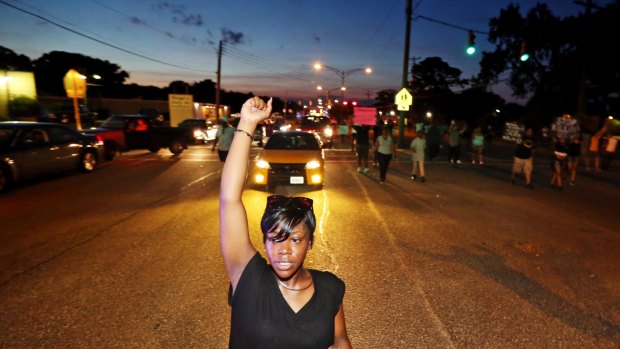 Sirica Bolling raises her fist during a Black Lives Matter protest against police brutality in Newport News, Virginia, on Sunday.