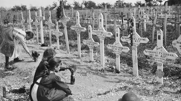 French children tending the graves of fallen Australians at Adelaide Cemetery, Villers-Bretonneux.