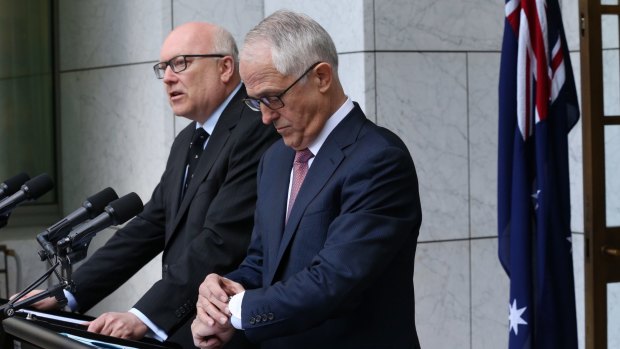 Prime Minister Malcolm Turnbull stood with Attorney-General George Brandis as he made the High Court announcements.