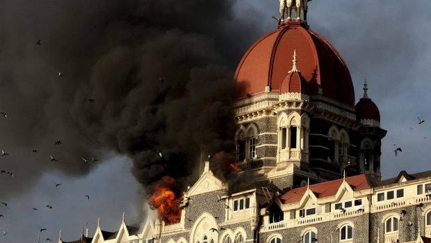 Under attack: Flames and smoke gush out of the Taj Mahal Hotel in Mumbai following the terror attacks in November 2008.

  
