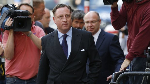 Former <i>News of the World</i> chief reporter Neville Thurlbeck arrives for sentencing at the Old Bailey in 2014.