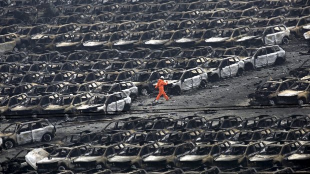 A firefighter searches for survivors at the site of the explosions.