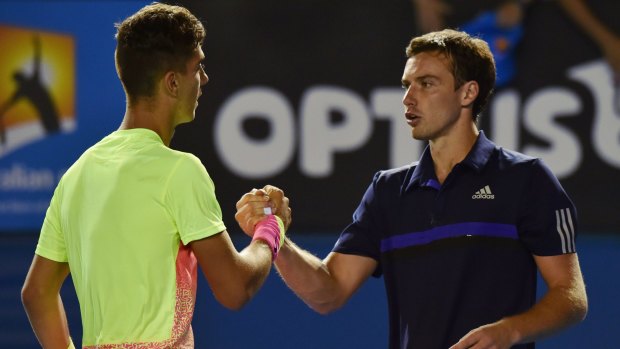 Kokkinakis is congratulated by the man he defeated, Ernests Gulbis.