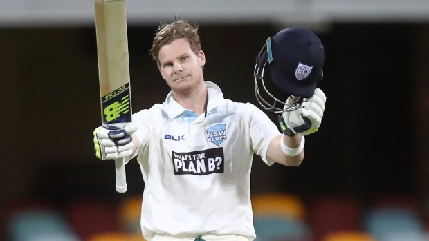 Big Blue: NSW captain Steve Smith salutes the crowd after reaching his ton. 
