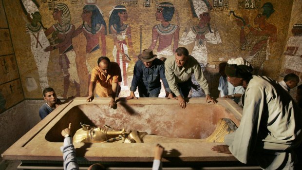 Egypt's then antiquities chief Dr Zahi Hawass, centre, supervises the removal of King Tut from his stone sarcophagus in his underground tomb in the Valley of the Kings, Luxor, in 2007.