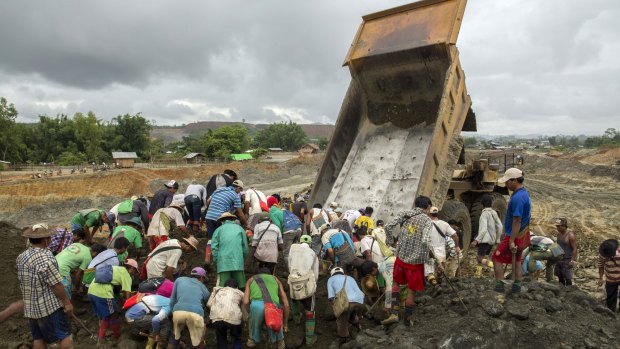 Jade miners search for raw jade stones in an earth dump from a company's truck in Hpakant area, Kachin State in June.