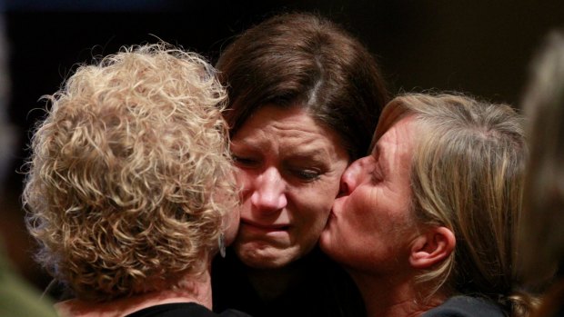 United in loss: Three of the mourners at Melbourne's St Patrick's Cathedral on Thursday. 