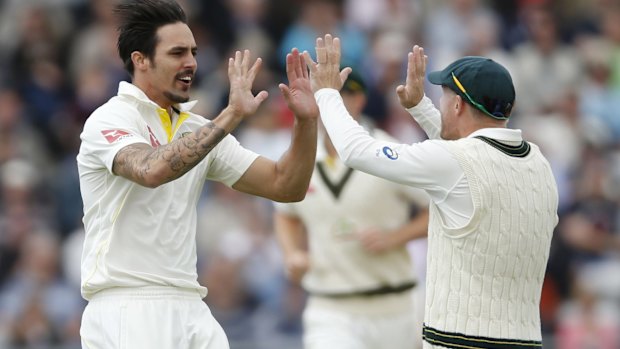 Breakthrough: Mitchell Johnson celebrates with David Warner after dismissing Jonny Bairstow.