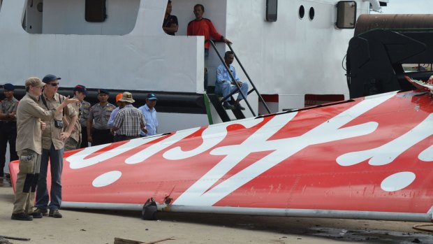 Foreign investigators examine the tail of the AirAsia flight QZ8501 in Kuma.