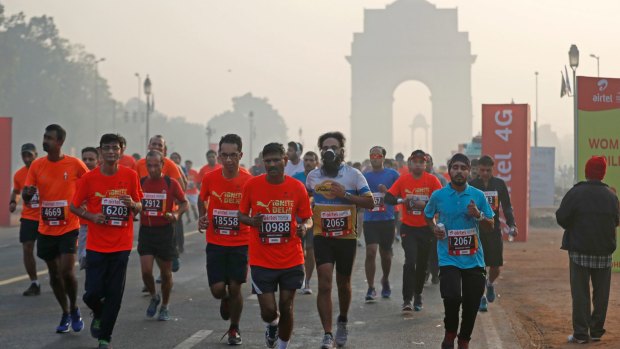 Competitors battle through polluted conditions in the Delhi Half Marathon on November 20.