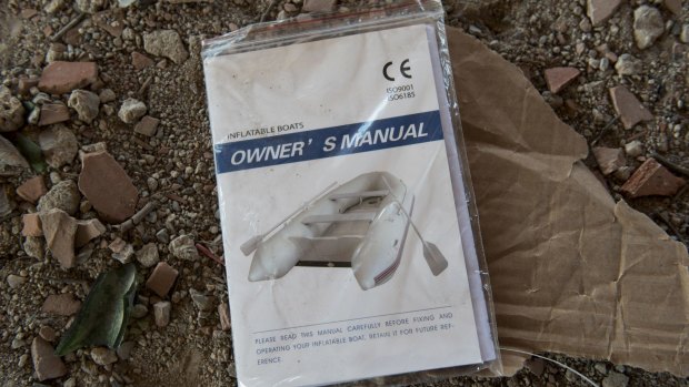 An inflatable boat manual lies in an abandoned house, in Cesme, Turkey, used by migrants as shelter before departing for the Greek island of Chios.