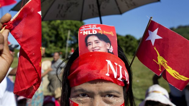 A supporter displays a picture of Myanmar opposition leader Aung San Suu Kyi in her headband earlier this month.