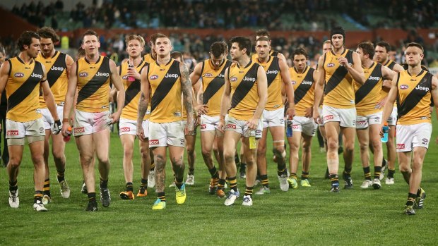 Dejected Tigers leave the field after losing to Port Adelaide.