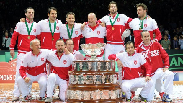 Centre of attention: Australian David Macpherson (centre), with members of the victorious Swiss Davis Cup team.