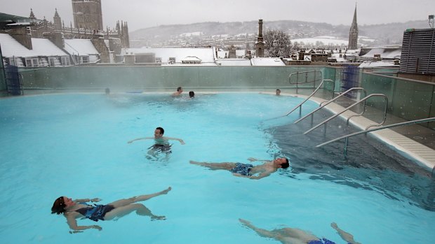 Bathers enjoy the rooftop pool at the Thermae Bath Spa.