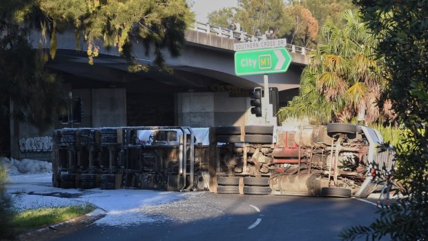 The truck rolled near Sydney Airport about 3.50am, spilling hundreds of litres of fuel and causing peak-hour traffic chaos.