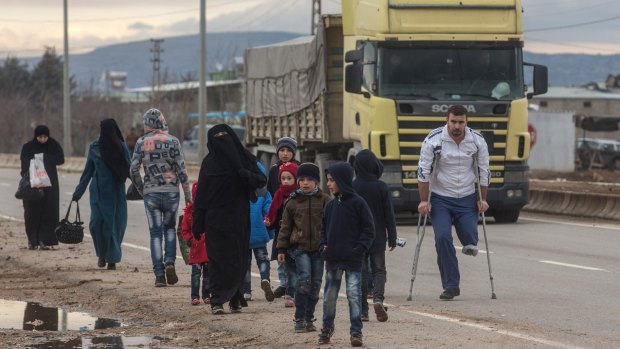 Syrians fleeing a government offensive and Russian air strikes try to cross the border into Turkey  this month.