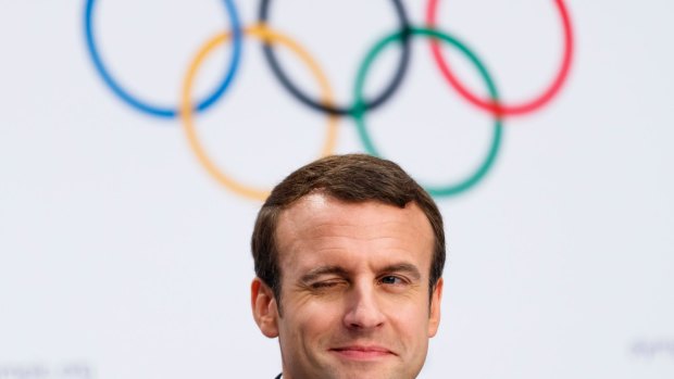 French President Emmanuel Macron winks during Tuesday's press conference.