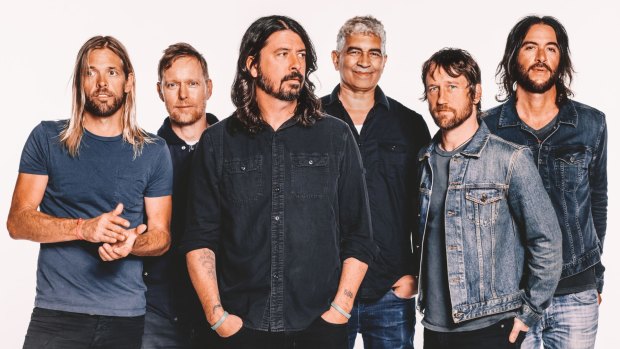 Dave Grohl (centre) will bring the Foo Fighters to Australia in January as part of their world tour.