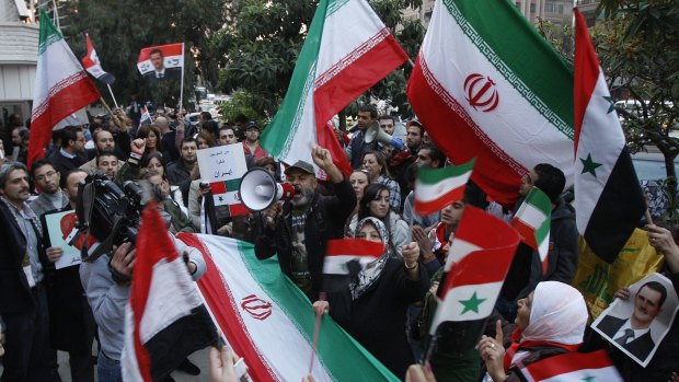 Pro-Syrian government protesters shout slogans and wave Iranian and Syrian flags in front the Iranian embassy to thank Iran for its support of the Syrian government.