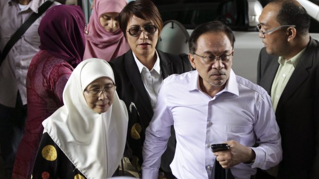 The former opposition coalition leader Anwar Ibrahim with his wife Wan Azizah, in February. Mr Anwar was jailed for five years for sodomy.