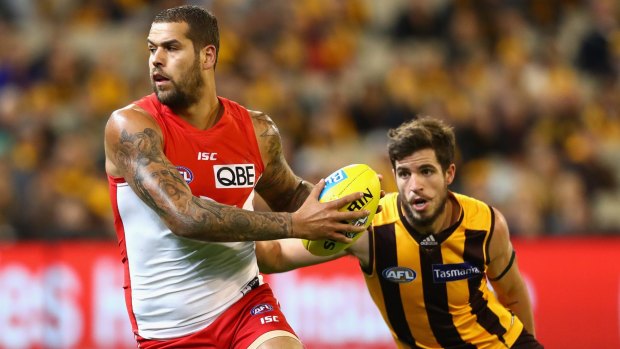 Sydney's Lance Franklin of the Swans attempts to avoid a tackle by Hawthorn's Ben Stratton on Friday night.