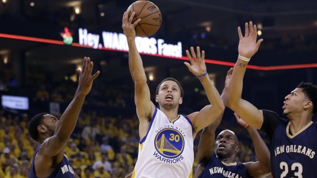 Scoring machine: Golden State Warriors guard Steph Curry shoots past New Orleans Pelicans defenders Tyreke Evans, Quincy Pondexter and Anthony Davis.