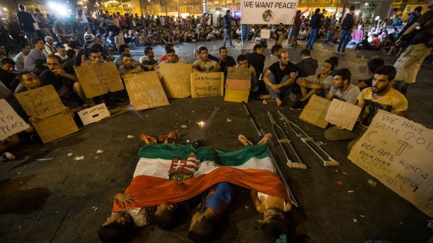 Migrant children sleep under a Hungarian flag in front of Keleti station in central Budapest on Wednesday.