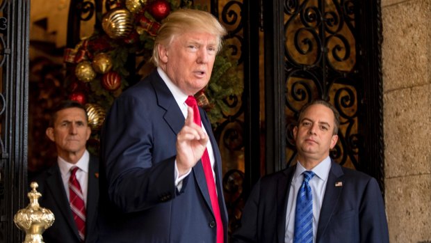 Then president-elect Donald Trump accompanied by chief of staff Reince Priebus, right, and retired general Michael Flynn in December.