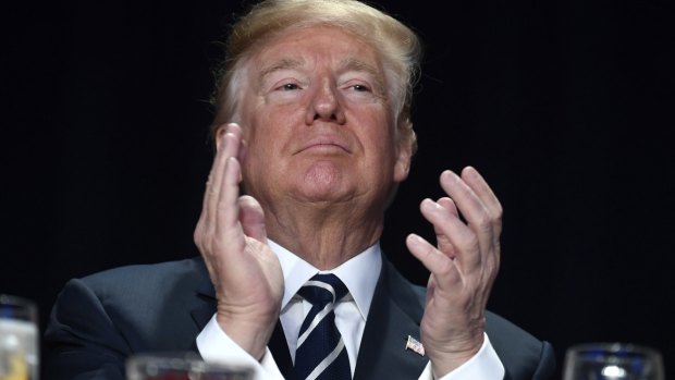 US President Donald Trump applauds during the National Prayer Breakfast in Washington earlier this month. 