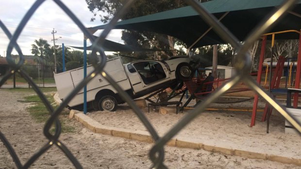 The ute, mounted the curb and knocked down a fence before landing on the play equipment.