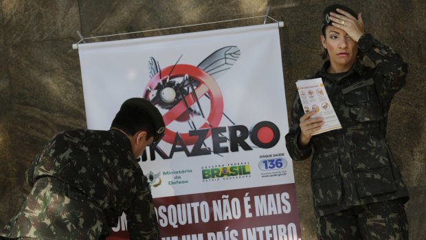 Brazilian soldiers set up a sign that reads "A mosquito is not stronger than an entire country" at the Central station in Rio de Janeiro.