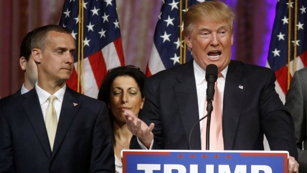 Donald Trump's former campaign manager Corey Lewandowski listens at left as Trump speaks in Florida.