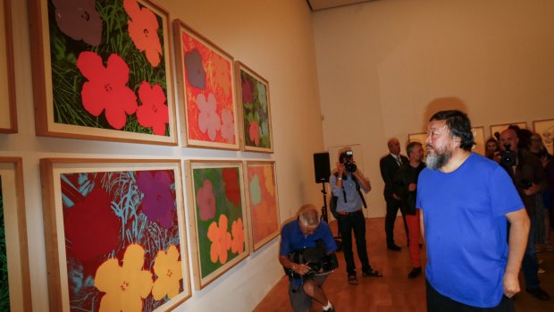 Ai Weiwei views Andy Warhol's 1970 Flowers screenprint at the NGV.