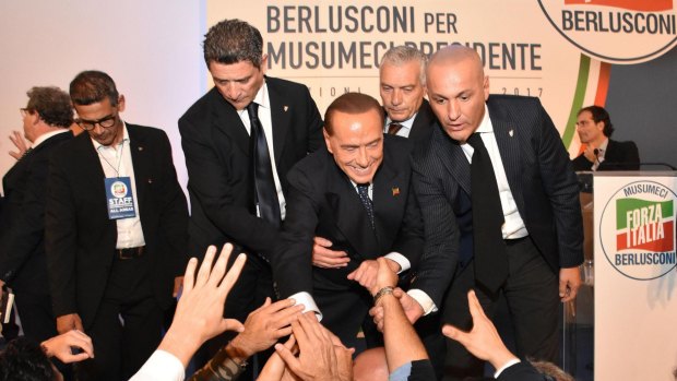 Italian former PM and leader of 'Forza Italia' party, Silvio Berlusconi, greets his supporters during an electoral meeting to support the center-right Forza Italia party.