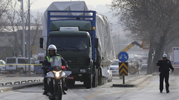 Police remove a destroyed bus from the scene of Wednesday's explosion in Ankara.