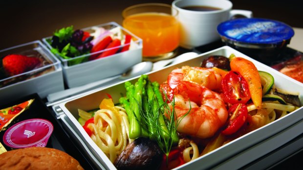 An economy class meal on Singapore Airlines. The compartmentalised courses, the possibility of a tiny chocolate bar hidden beneath the cutlery pack, a screen inches from my face – they never lose their shine.  