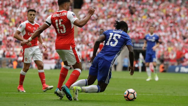 Pivotal moment: Victor Moses falls untouched in the penalty area, leading to a second yellow card, reducing the league champions to ten men.