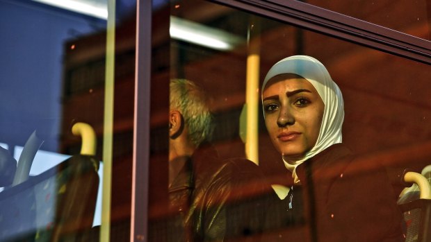 A Syrian refugee on a bus after arriving in Piraeus near Athens. Some 1800 predominantly Syrian refugees crossed the sea from Turkey to the Greek island of Lesbos last month. 