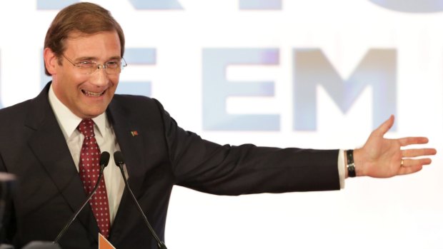 Portuguese Prime Minister Pedro Passos Coelho gestures following the announcement of the results of Portugal's general elections on Sunday.