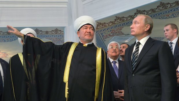 Russian President Vladimir Putin, right, and Palestinian President Mahmoud Abbas, centre back, accompanied by Russia's most senior Muslim cleric Ravil Gainutdin, left, visit the main mosque after its opening ceremony on Wednesday. 