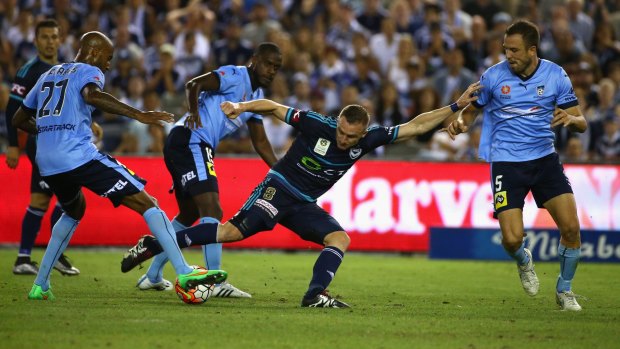 Stifling defence: Victory star Besart Berisha is surrounded by Sydney players.