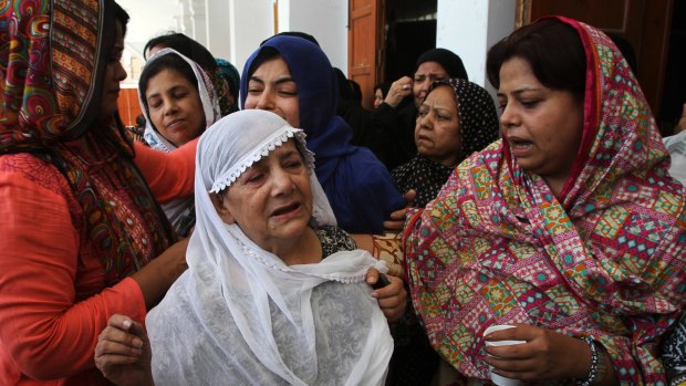 Relatives mourn the death of activist Khurram Zaki in Karachi.