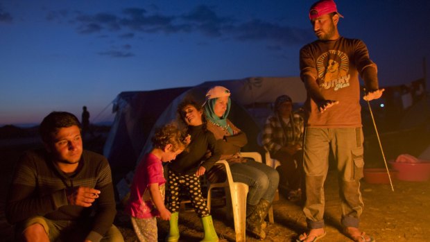 Refugees from Syria sit around a fire at the informal camp in Idomeni, Greece, waiting for a chance to travel elsewhere in Europe. 